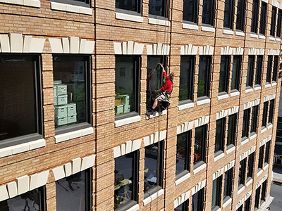 Commercial window cleaning services on brick, low rise building