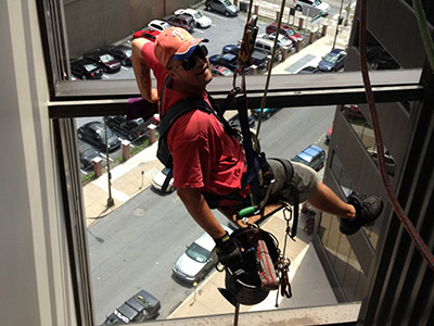 Man Using Rope Access on Building Interior