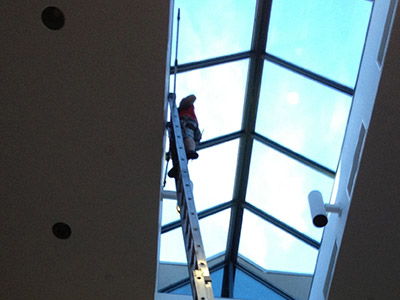 Using Ladder to Clean Skylight