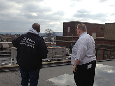 Two Men Talking On top of Building
