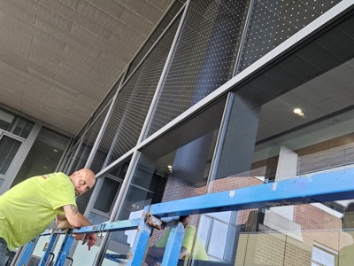 PSI technician installing Feather Friendly Bird Dot System at Penn State